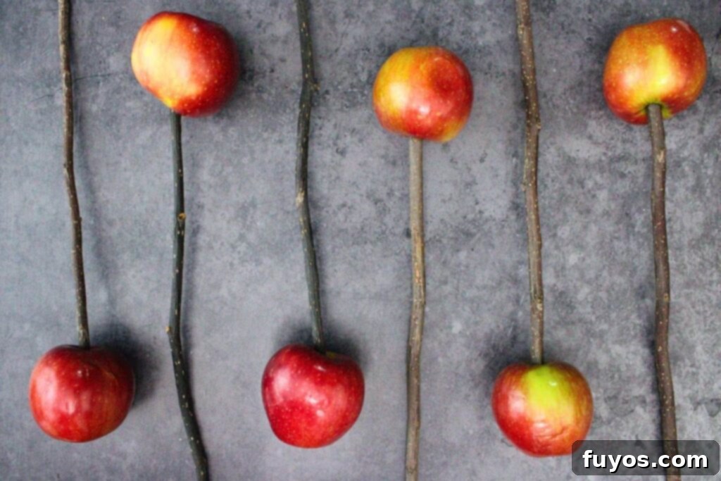 No-Bake Caramel Apple Broomsticks 5 skewer each apple with a broomstick twig
