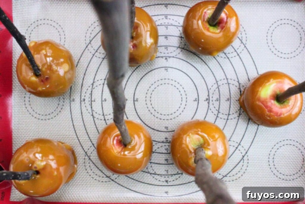 No-Bake Caramel Apple Broomsticks 7 dip and coat apples in hot caramel