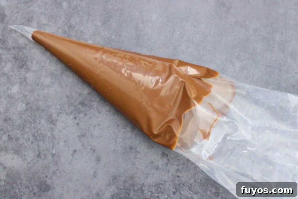 No-Bake Caramel Apple Broomsticks 8 transfer melted chocolate into piping bag