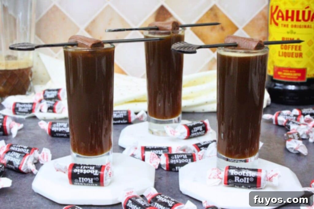 Tootsie Roll Shots Your Favorite Candy Grown Up 3 three tootsie roll shots on coasters with candy skewers surrounded by wrapped chocolate candies