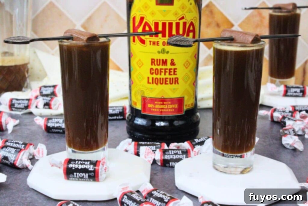 Tootsie Roll Shots Your Favorite Candy Grown Up 8 two tootsie roll shots with a tootsie roll skewer and kahlua bottle in between