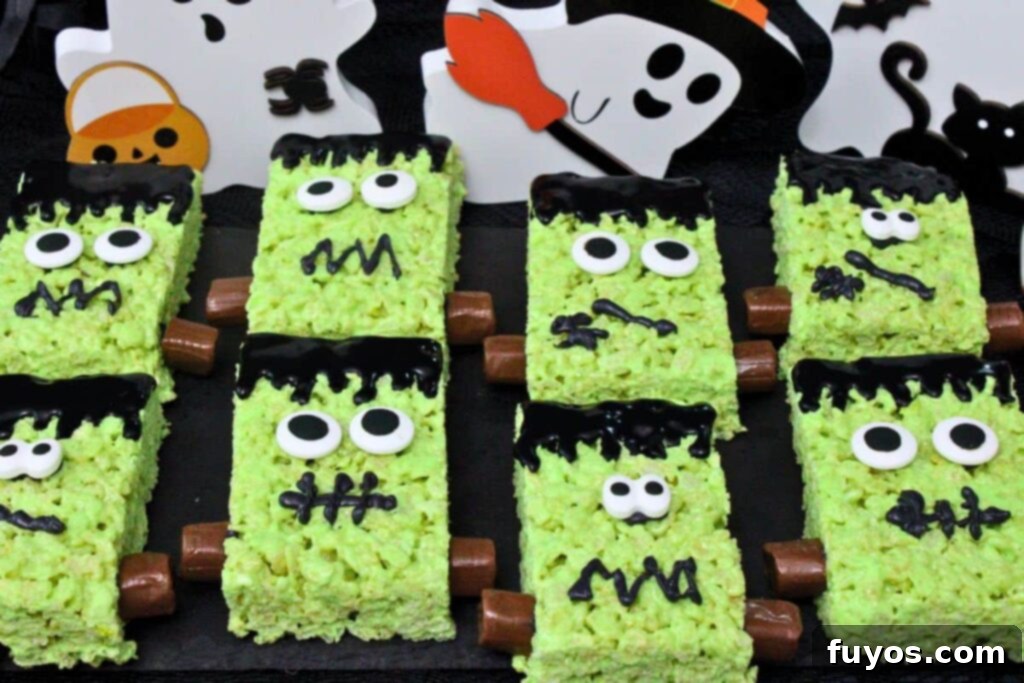 Conjure Up Frankenstein Krispie Monsters: No-Bake Halloween Magic 12 several frankenstein rice krispie treats with candy eyes and tootsie roll bolts on a black slate with ghost decorations