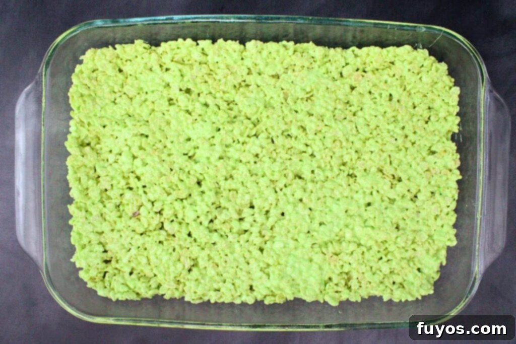 Conjure Up Frankenstein Krispie Monsters: No-Bake Halloween Magic 7 spread green rice krispie mixture in greased baking dish