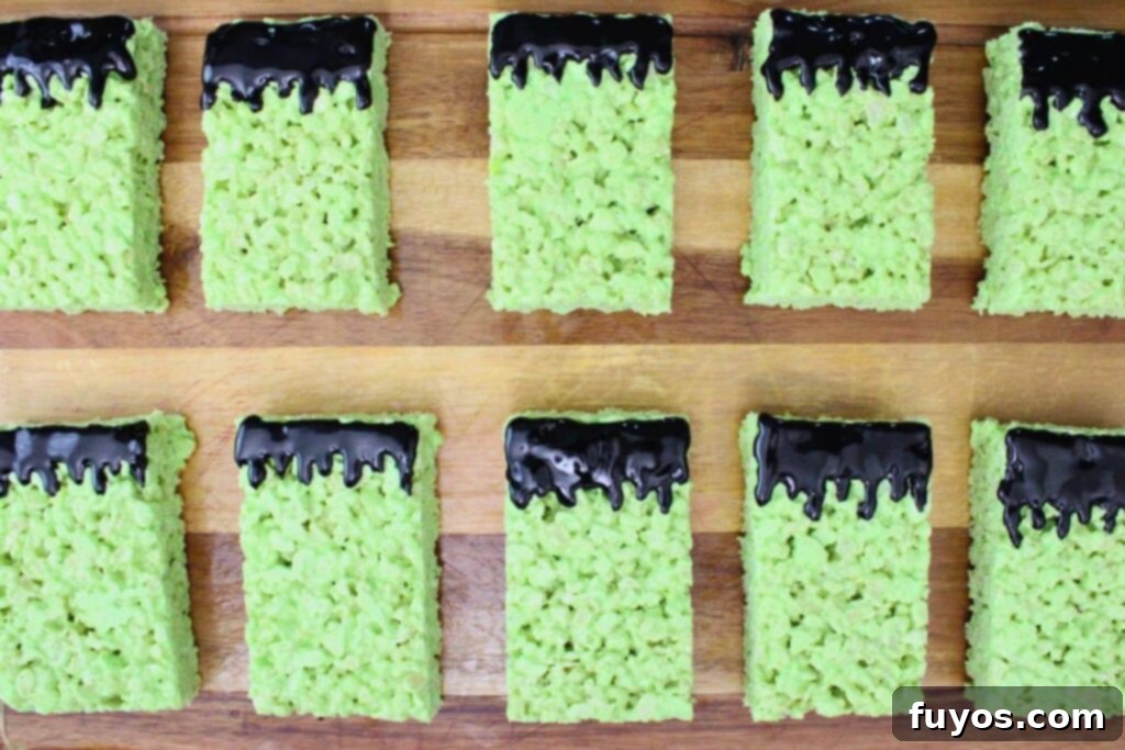Conjure Up Frankenstein Krispie Monsters: No-Bake Halloween Magic 9 add hair to frankenstein krispie treats using black cookie icing