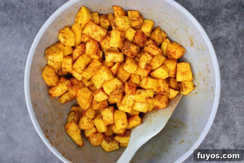 Air Fryer Halloween Monster Pumpkin Nachos 5 toss cubes pumpkin in seasonings