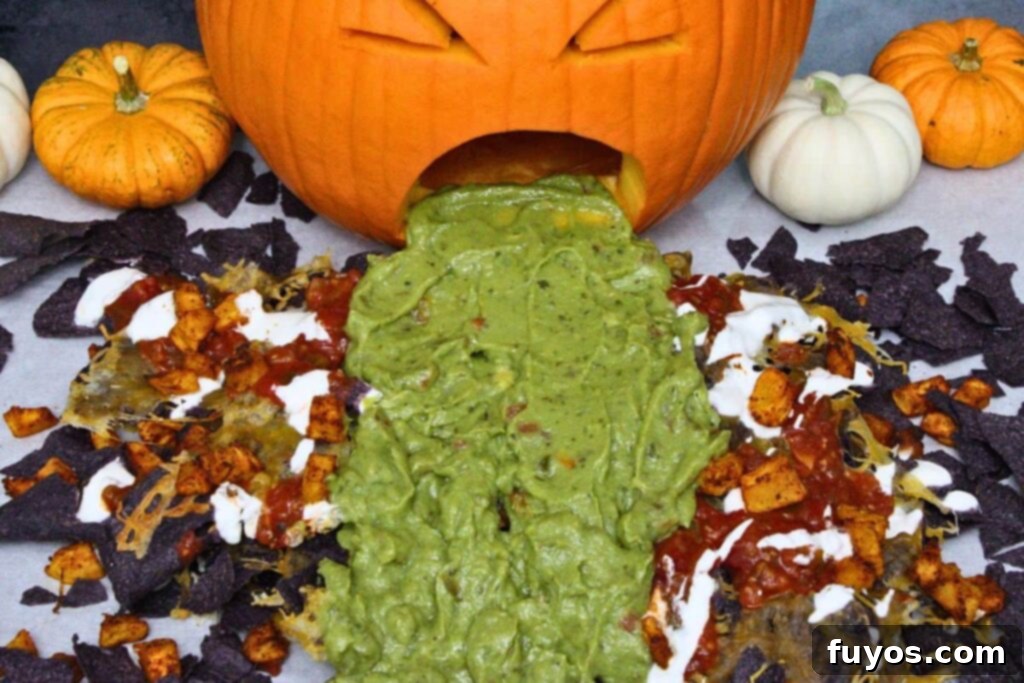 Air Fryer Halloween Monster Pumpkin Nachos 10 overhead view of halloween nachos with guacamole puking pumpkin decoration