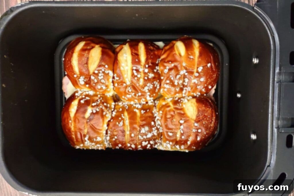 place ham and cheese pretzel sliders into air fryer basket