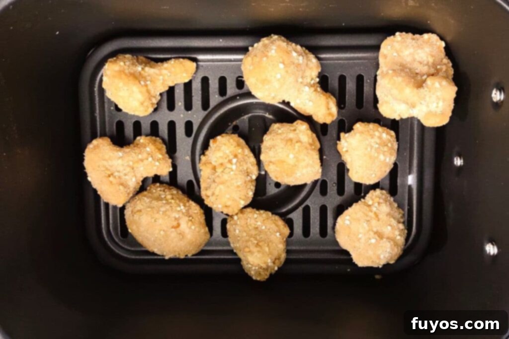frozen cauliflower wings in an air fryer basket