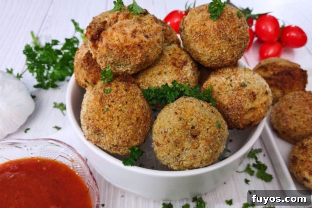 Crispy Air Fryer Arancini Mozzarella Stuffed Rice Balls 14 air fryer mozzarella arancini in a bowl with marinara on the side, ready for serving
