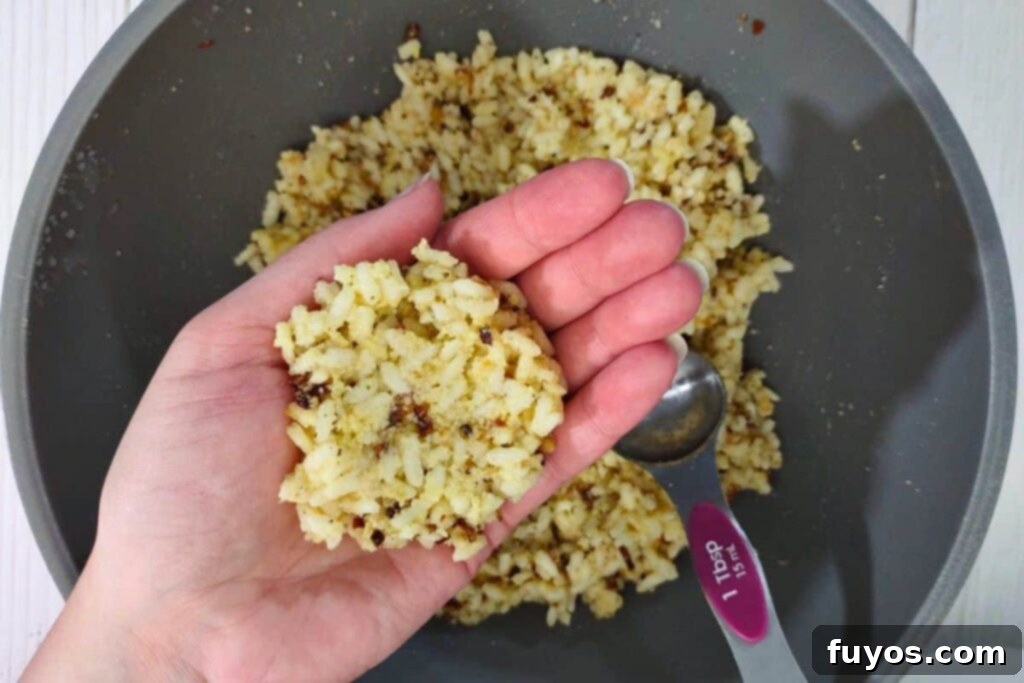 Crispy Air Fryer Arancini Mozzarella Stuffed Rice Balls 7 spoon the rice mixture into your hand, ready for shaping