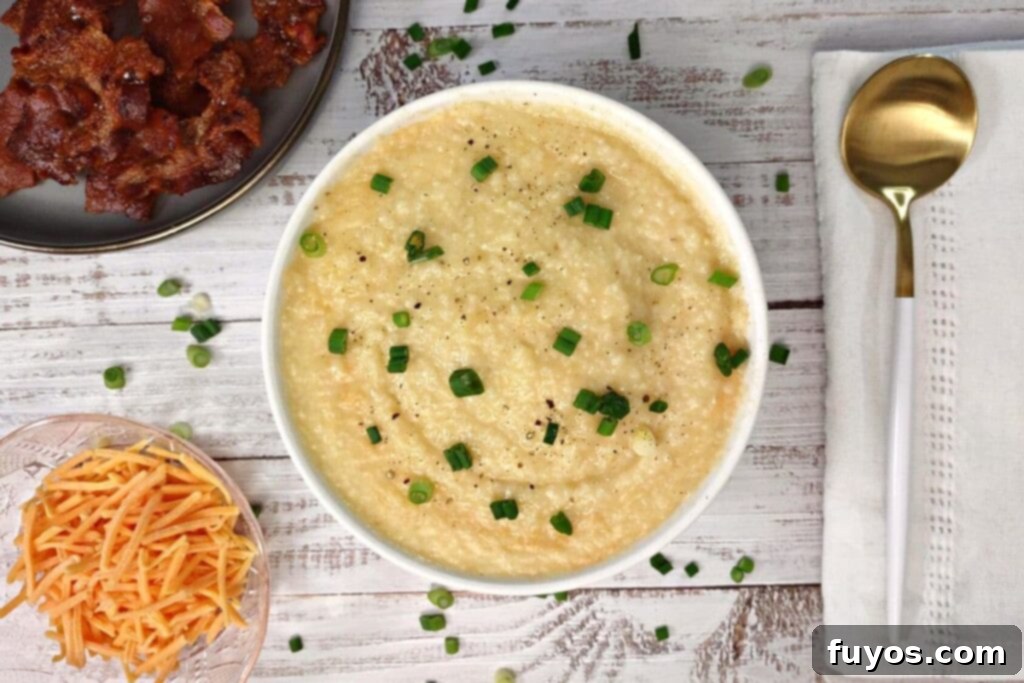 Velvety Garlic Cheese Grits in Minutes 10 overhead view of microwave grits in a bowl with shredded cheese and bacon to the side
