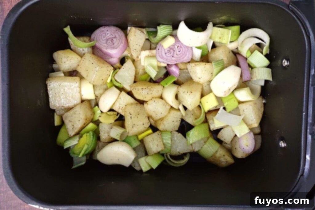 Creamy Air Fryer Leek and Potato Soup Pure Comfort Made Easy 10 Add shallots, leeks, and garlic cloves to potatoes in air fryer basket