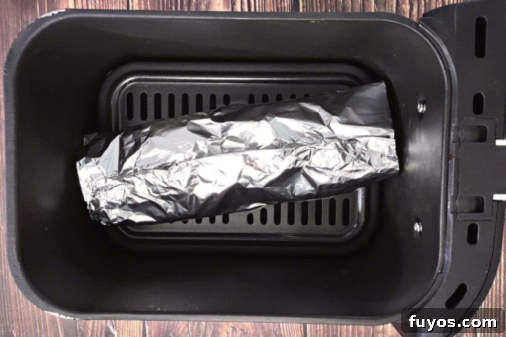 Quick and Easy Air Fried White Castle Sliders From Frozen 8 Placing the foil-wrapped slider packet carefully into the air fryer basket for cooking