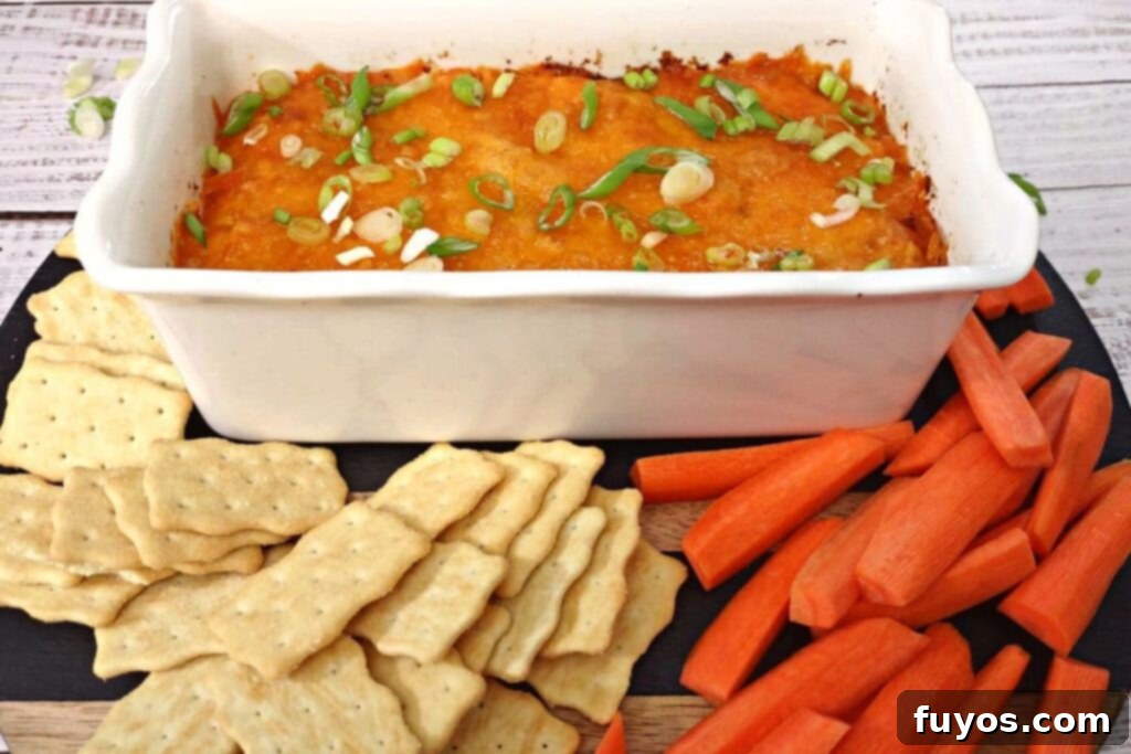 Ultimate Air Fryer Buffalo Chicken Dip 10 Buffalo chicken dip served with crisp carrots and crackers, ready for a gathering.