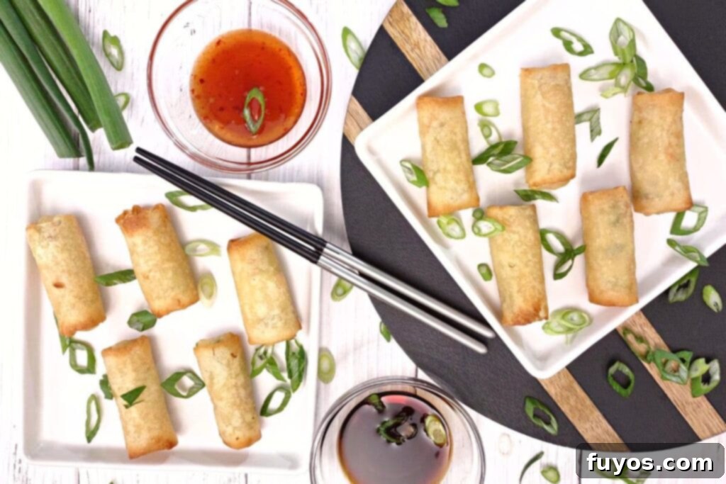 Crispy Air Fryer Spring Rolls in 5 Minutes 6 overhead view of reheated air fryer spring rolls on white plates