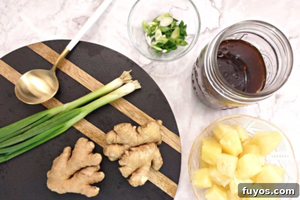 10-Minute Homemade Microwave Teriyaki 9 overhead view of teriyaki sauce in a jar with fresh ginger, scallions, and pineapple