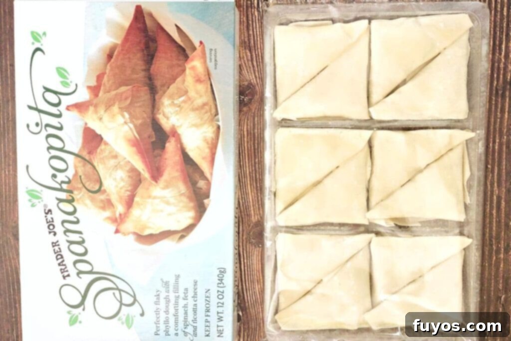 Trader Joe's Spanakopita Air Fryer Crispy Snack 4 Trader Joe's frozen spanakopita box next to individual triangles, highlighting the main ingredient