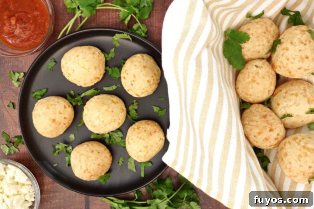 overhead view of trader joes brazilian cheese bread on a plate next to a full basket