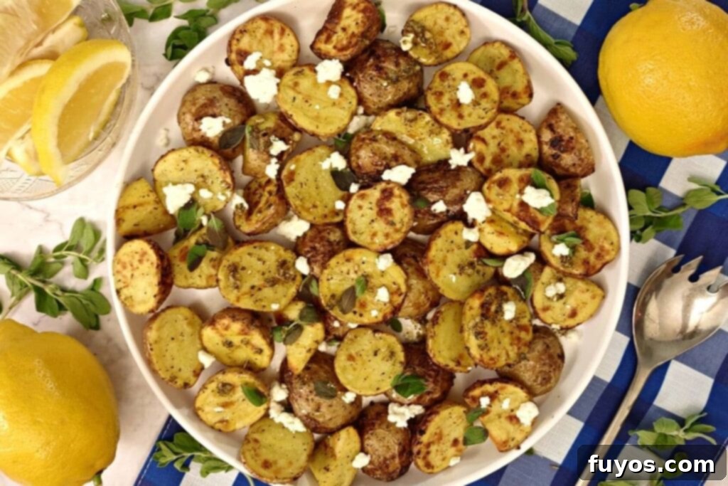 overhead view of air fryer greek potatoes on a plate with feta cheese
