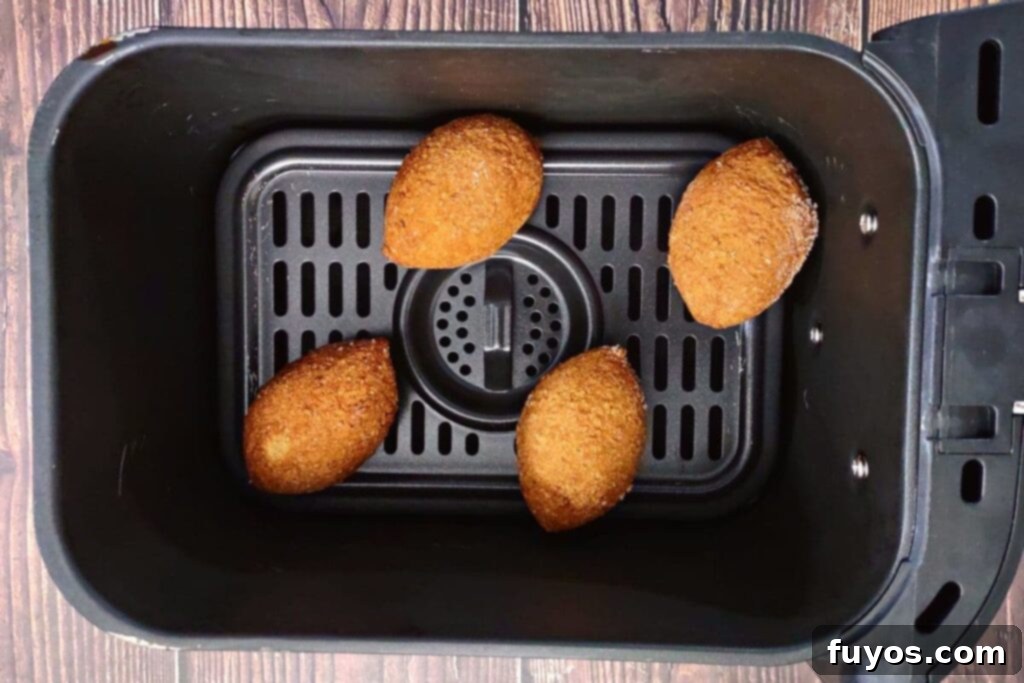 Trader Joe's Kibbeh Air Fryer Magic: Effortless Middle Eastern Flavor 5 Trader Joe's frozen kibbeh arranged neatly in an air fryer basket