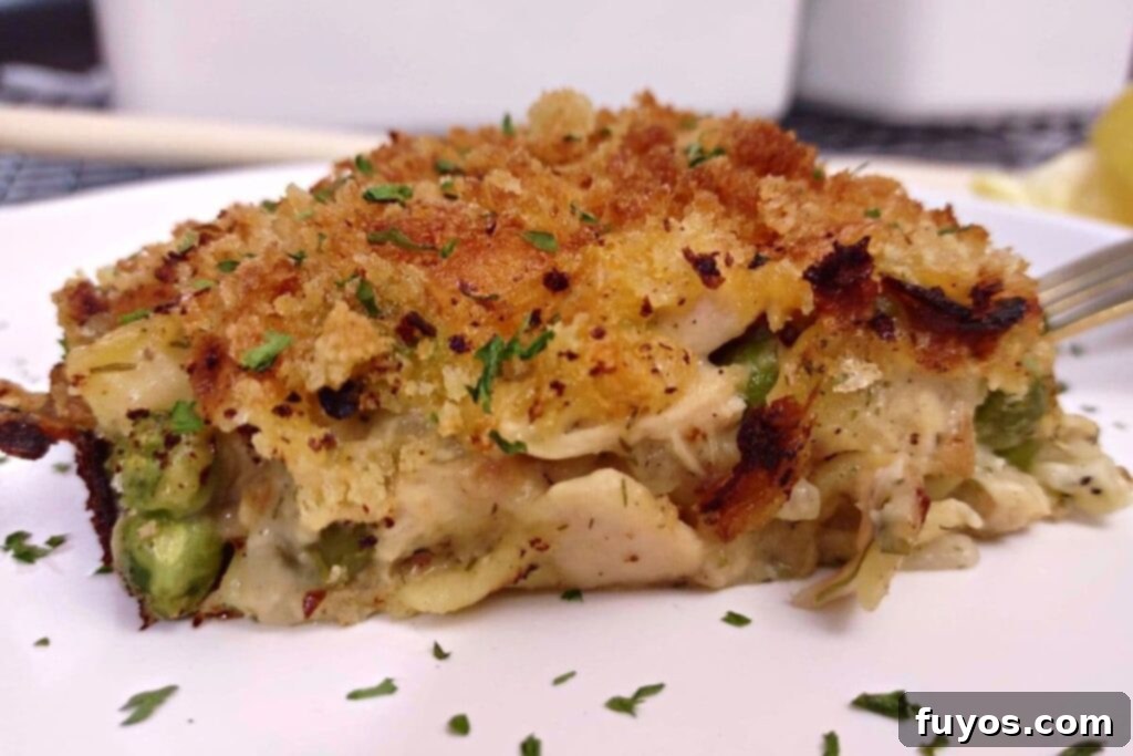 Air Fryer Tuna Casserole Your Perfect Comfort Indulgence 3 Close-up of creamy tuna noodle casserole in an oven-safe dish inside an air fryer basket.