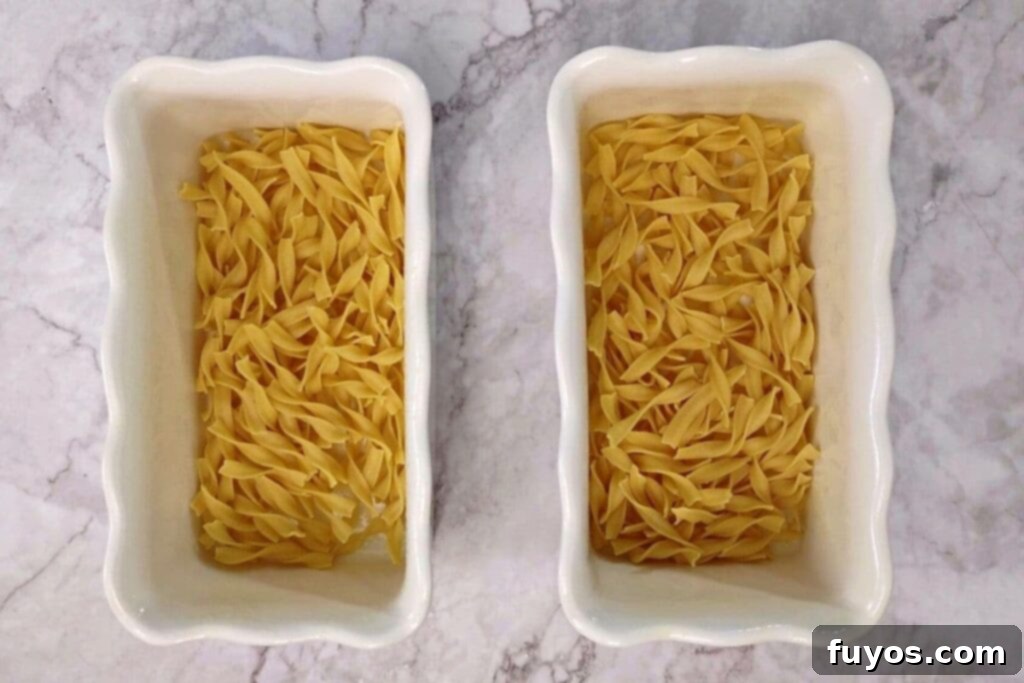 Air Fryer Tuna Casserole Your Perfect Comfort Indulgence 5 Dry egg noodles laid out in a greased oven-safe dish for air fryer tuna casserole.