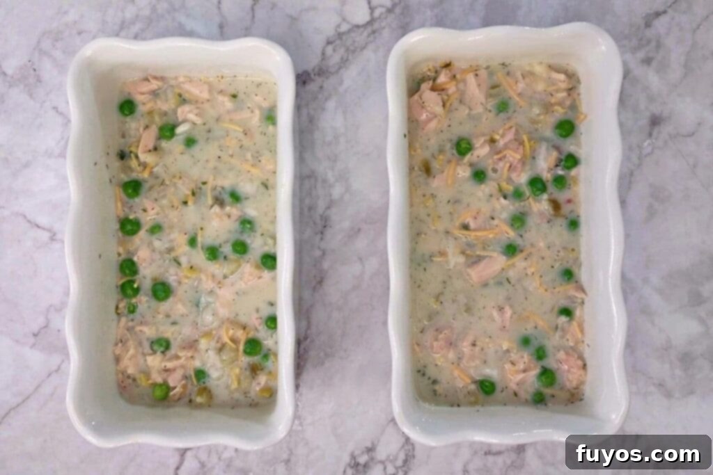 Air Fryer Tuna Casserole Your Perfect Comfort Indulgence 7 Pouring the tuna mixture over dry noodles in oven-safe dishes.