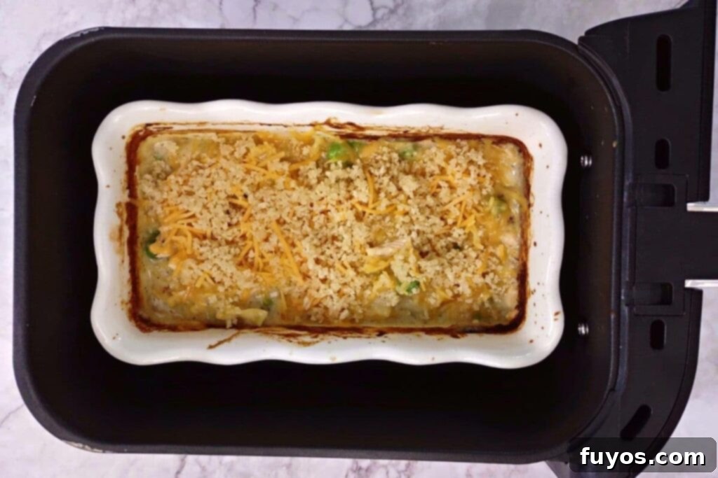 Air Fryer Tuna Casserole Your Perfect Comfort Indulgence 10 Adding panko breadcrumbs and remaining shredded cheddar cheese to the cooked tuna casserole before final air frying.