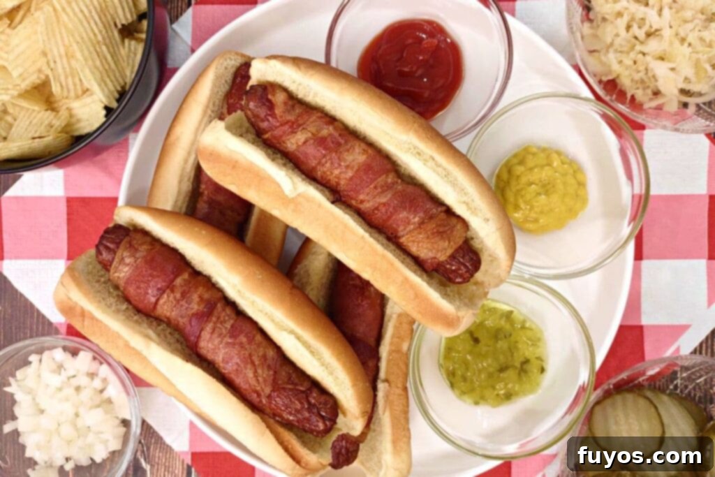 Air Fryer Bacon Hot Dogs: Crisp Perfection, Zero Fuss 8 overhead view of air fryer bacon wrapped hot dogs on a plate with ketchup and mustard