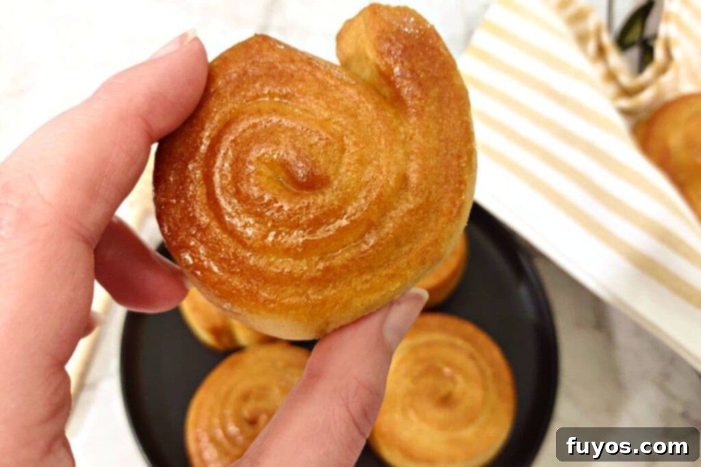 Pillsbury Cornbread Swirls The Quick and Easy Air Fryer Way 3 holding up an air fried honey butter cornbread swirl