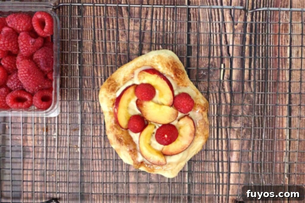 Air Fryer Sweet Fruit Mascarpone Dessert Pizza 13 top pizza with peach slices and raspberries