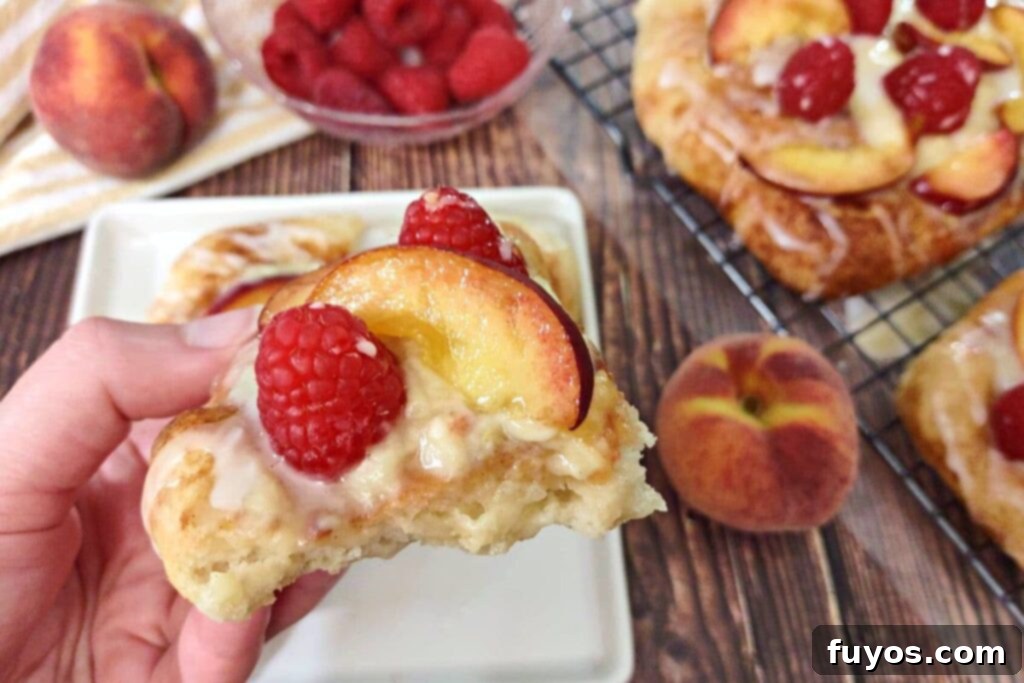 Air Fryer Sweet Fruit Mascarpone Dessert Pizza 3 holding up a slice of air fryer dessert pizza