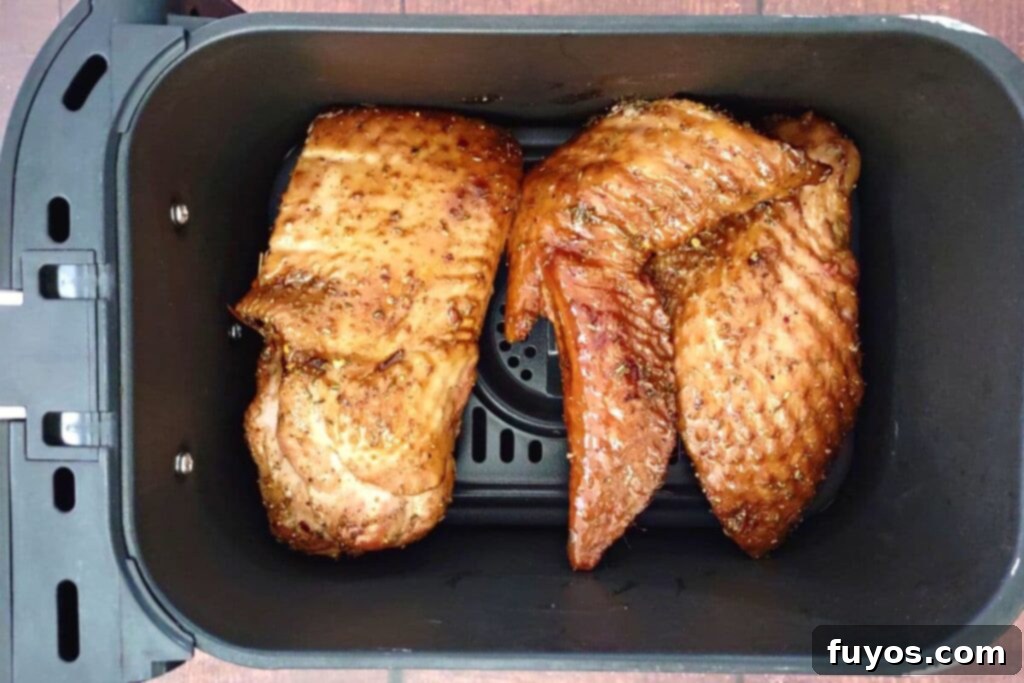 Smoked turkey wings arranged in a single layer in the air fryer basket
