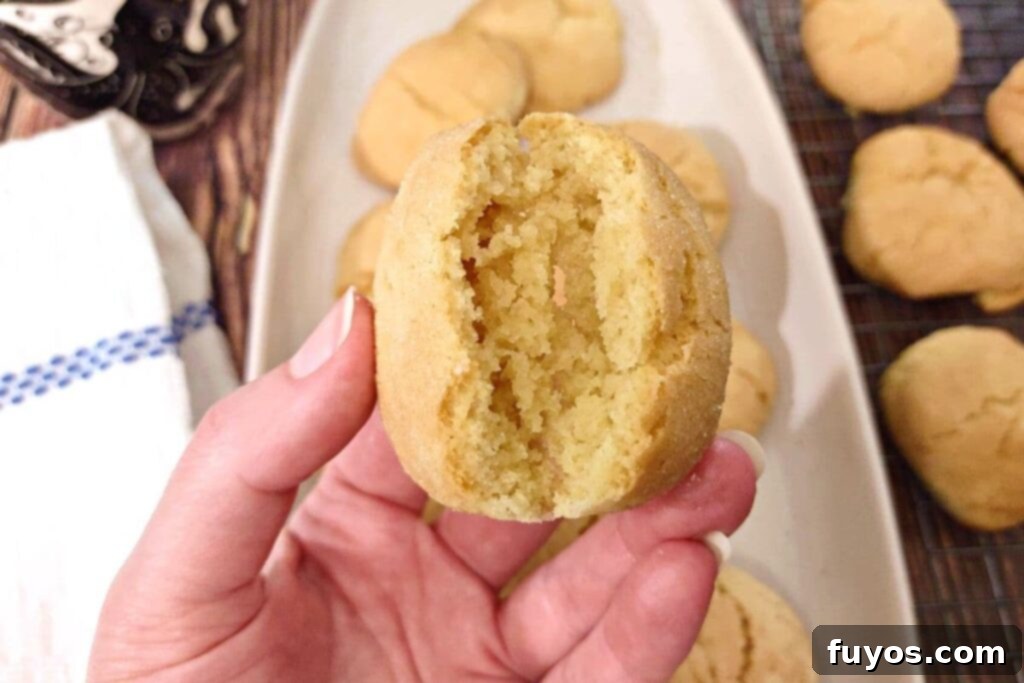 Southern Comfort Tea Cakes Air Fried 3 Breaking open a soft, warm air-fried tea cake to reveal its tender interior