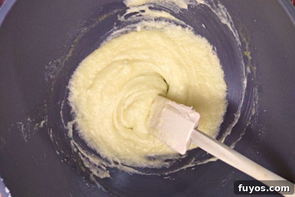 Southern Comfort Tea Cakes Air Fried 6 Adding egg, buttermilk, and almond extract to the tea cake batter.