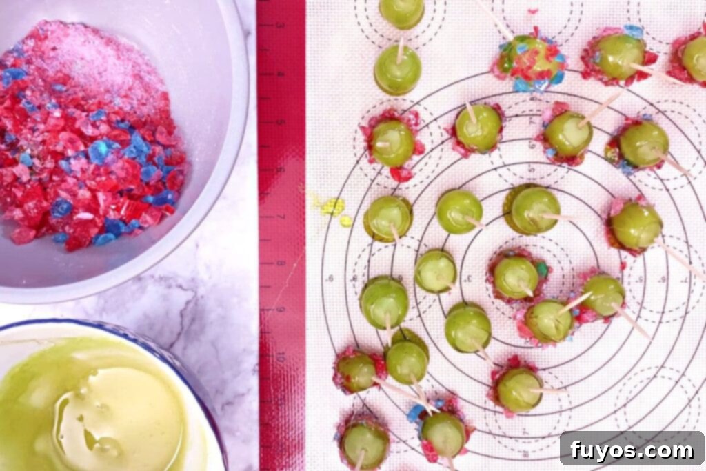 continue dipping your grapes in the melted candy until they are all finished