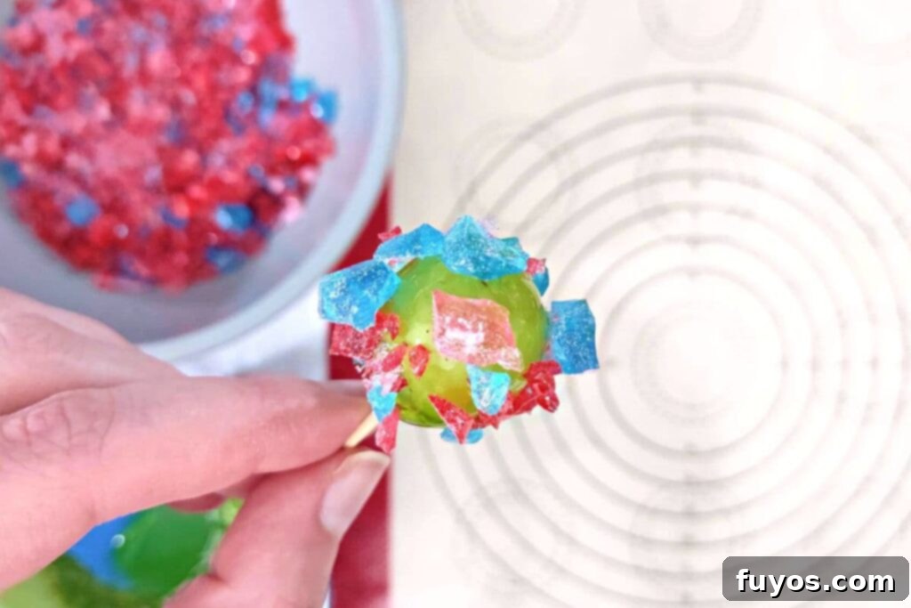 dip the coated grape in the crushed candy