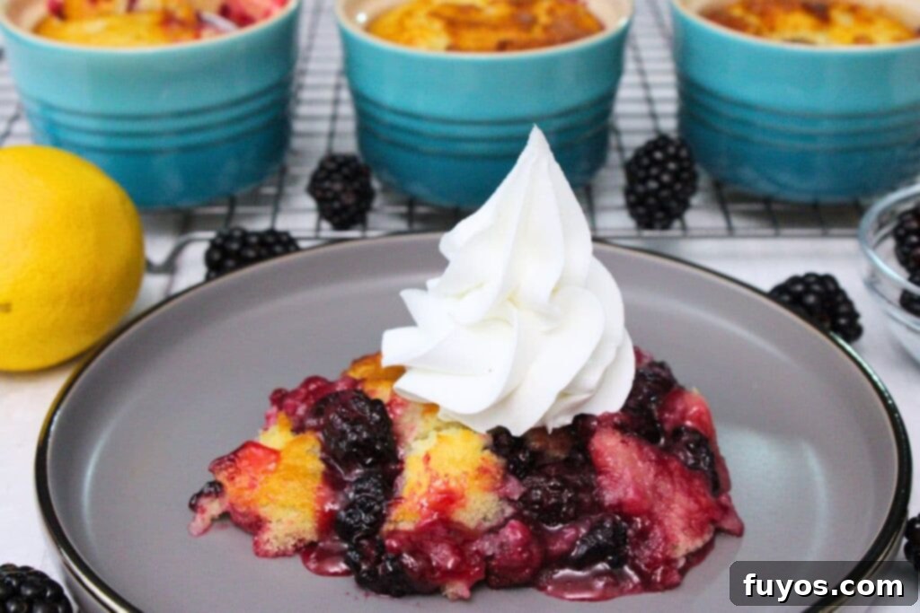 Effortless Air Fryer Blackberry Cobbler A Summer Delight 12 side view of air fryer blackberry cobbler topped with a whipped cream swirl