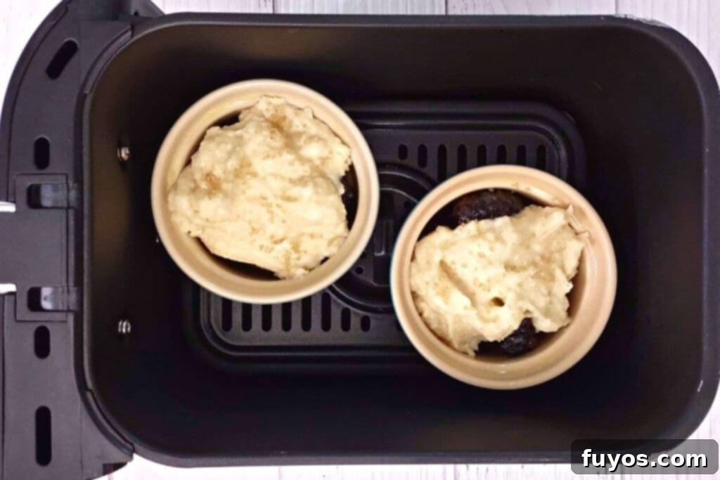 Effortless Air Fryer Blackberry Cobbler A Summer Delight 10 place filled ramekins in air fryer basket