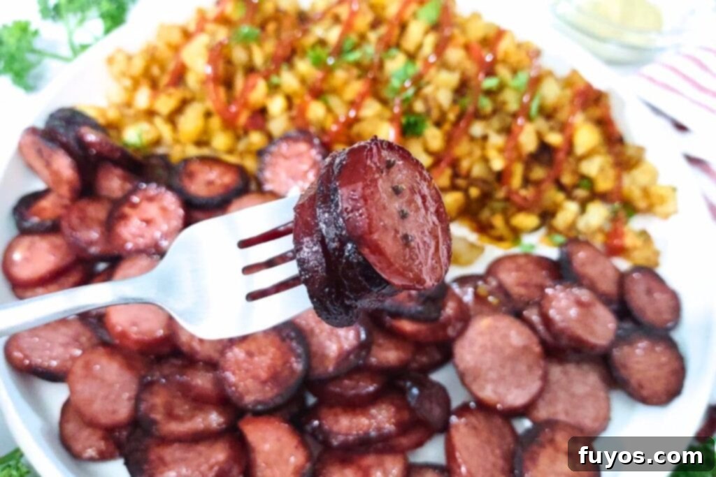 Perfect Smoked Sausage in Your Air Fryer 3 slices of air fried smoked sausage on a fork