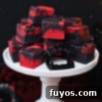 Vampire Fudge: A Sinfully Simple Halloween Indulgence 12 Vampire Fudge recipe, perfect for Pinterest, showing the dramatic red and black swirls of this easy no-bake Halloween dessert.