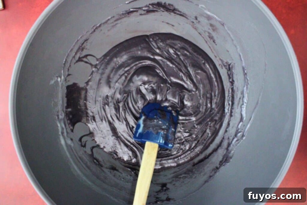 Vampire Fudge: A Sinfully Simple Halloween Indulgence 7 Black candy melts and the remaining sweetened condensed milk in a second microwave-safe bowl, ready for melting to create the dramatic contrasting layer for vampire fudge.