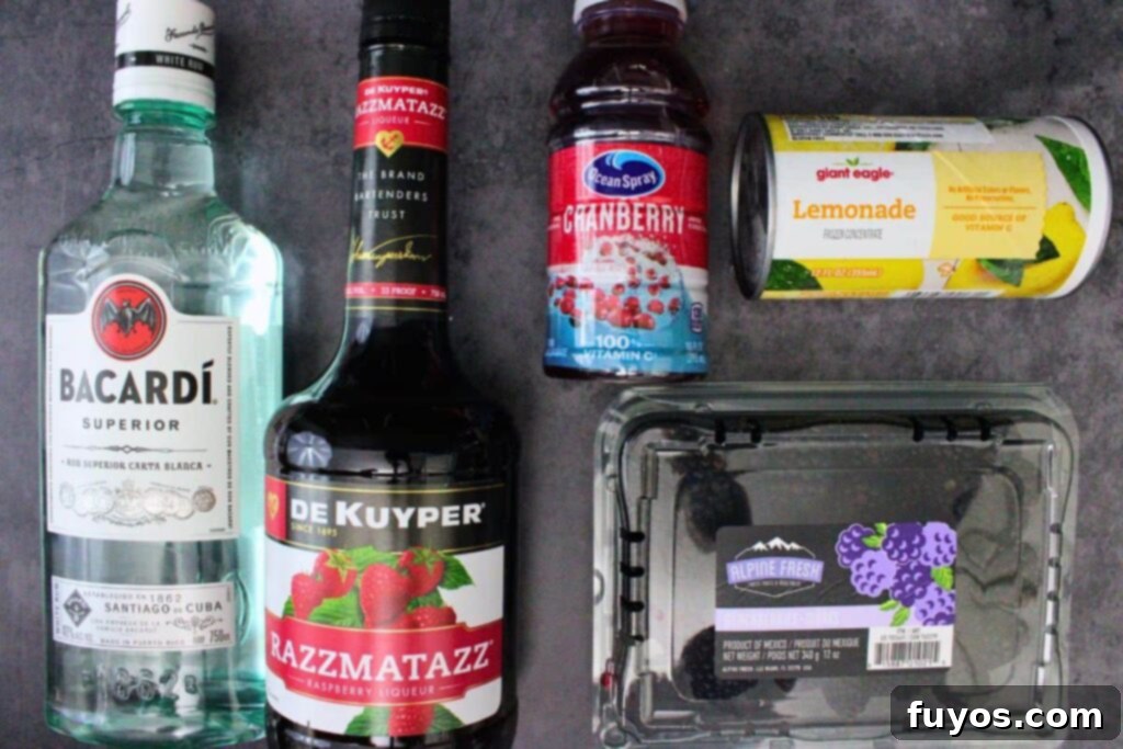 Make Your Own Dracula Juice for Halloween 4 Ingredients laid out to make Applebee's Dracula Juice, including rum, liqueurs, lemonade concentrate, and fresh blackberries.