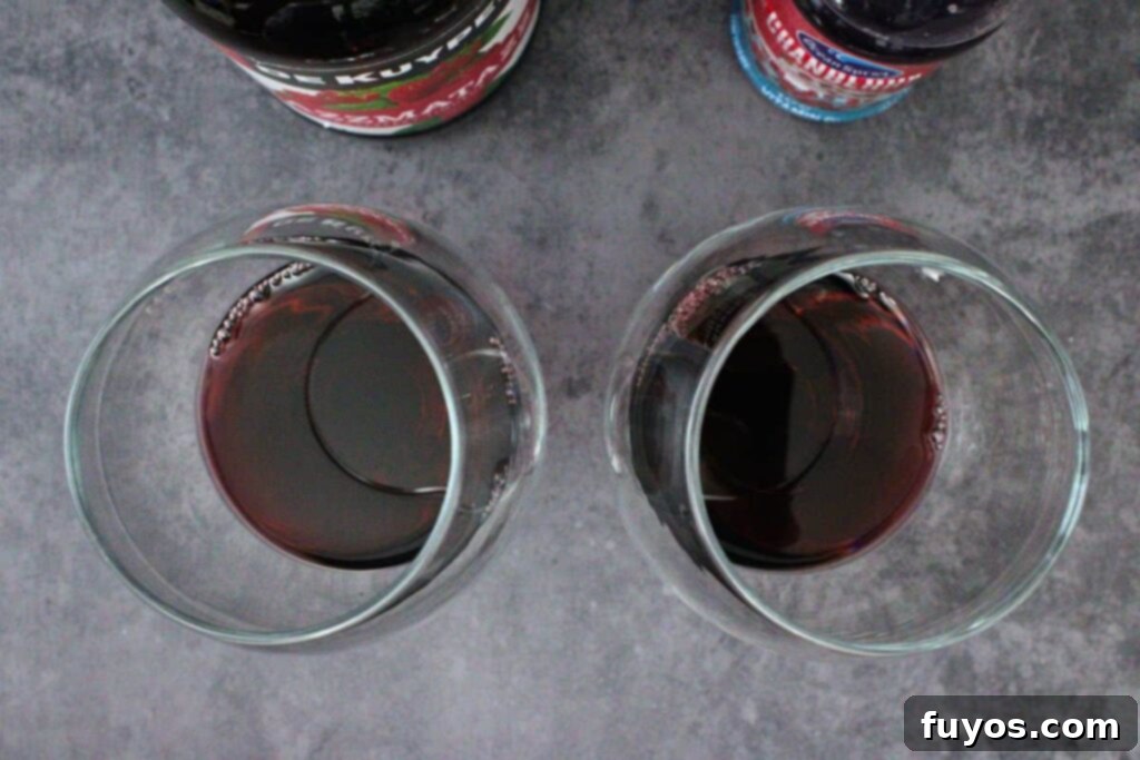 Make Your Own Dracula Juice for Halloween 5 Adding Razzmatazz and cranberry juice into a large Mucho glass for the red layer of the Dracula Juice.