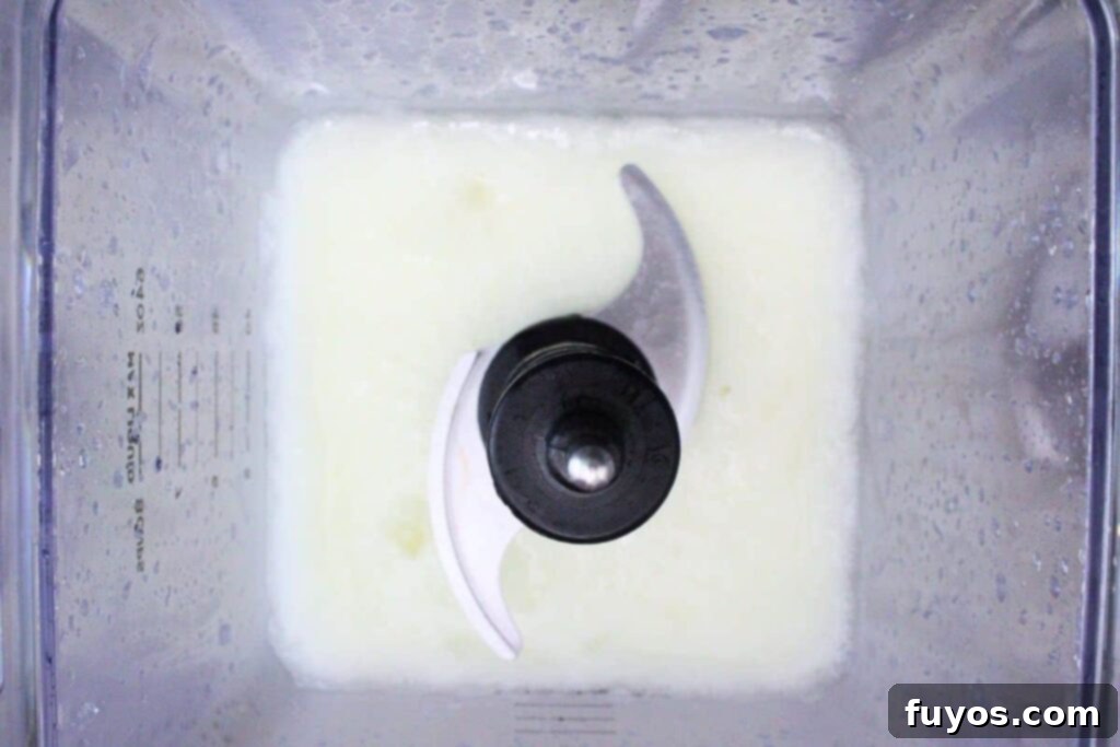 Make Your Own Dracula Juice for Halloween 6 Blending frozen lemonade concentrate with rum and ice to create the slushie layer for the Applebee's Dracula Juice.