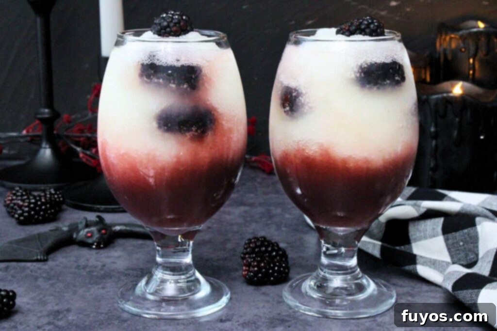 Make Your Own Dracula Juice for Halloween 9 Two Applebee's Dracula Juice cocktails side by side, showcasing fresh blackberries layered within the red and white frozen drink.