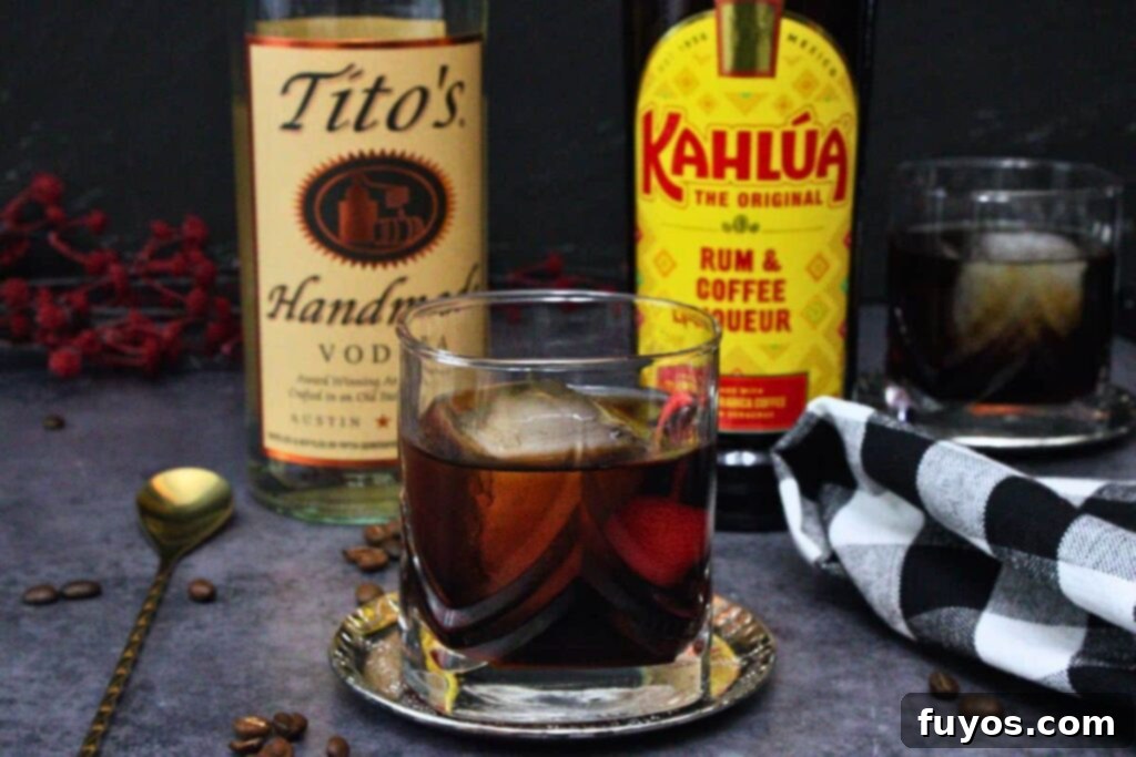 black russian drink in a rocks glass in front of vodka and kahlua bottles