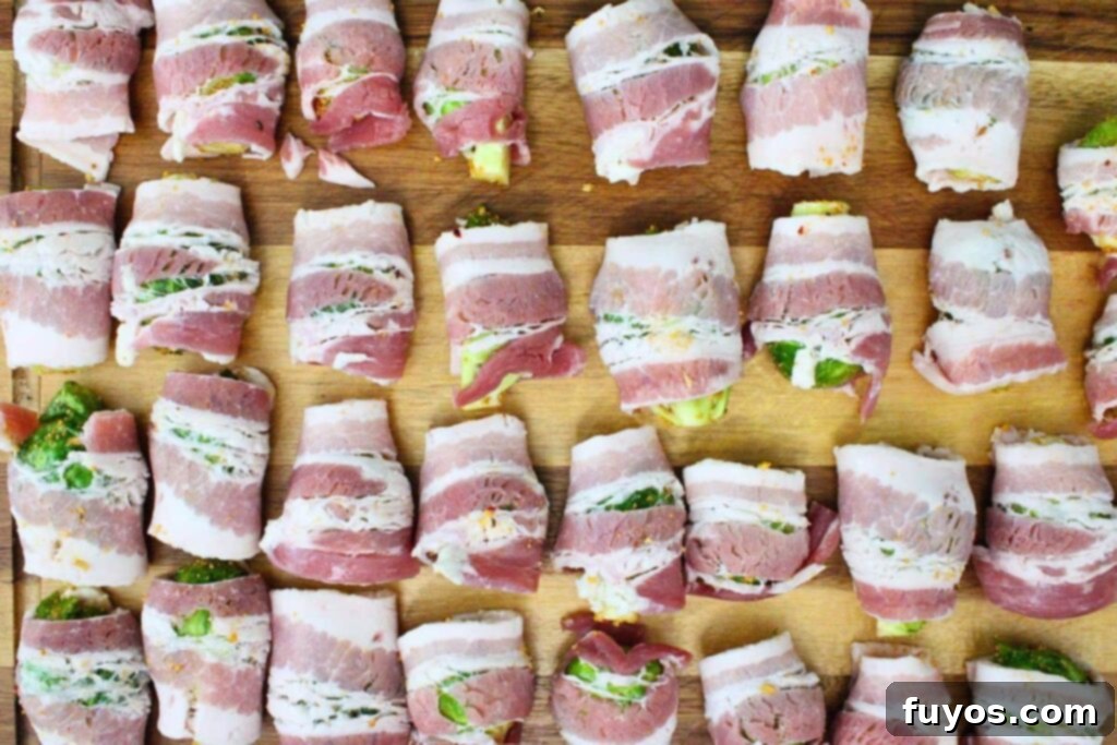 Wrapping each seasoned brussel sprout half in a piece of bacon