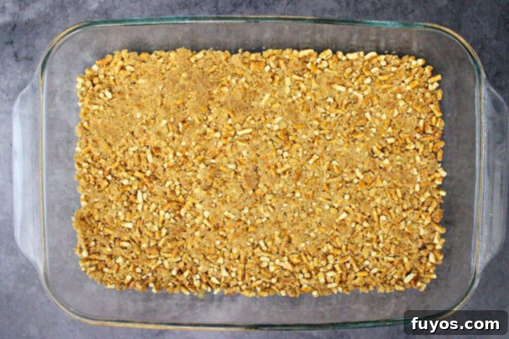 press crushed pretzel mixture into greased pan