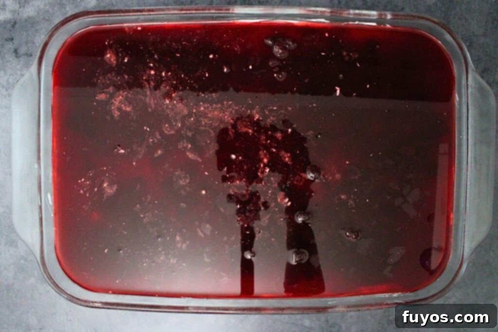 spread cooled cranberry jello mixture over cream cheese mixture